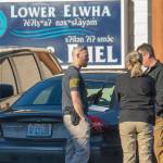 Oficials from the U.S. Marshals Service and Clallam County Sheriffs Office talk outside the Lower Elwha Food and Fuel where Ryan Ward was arrested. (Jesse Major/Peninsula Daily News)