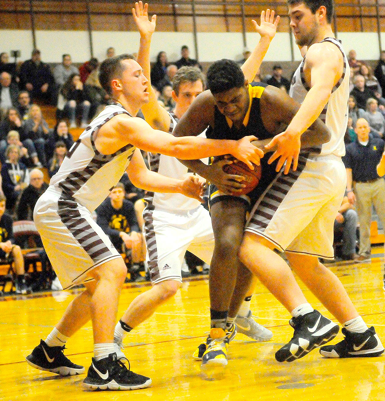 Hasani Grayson /Grays Harbor News Group                                Forks Trey Baysinger, center, is swarmed by Montesano defenders.
