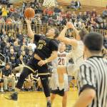 Lonnie Archibald/for Peninsula Daily News Forks Cort Prose drives and scores against Hoquiams Dane McMillian, 20, and Cameron Branstead. The Spartans won the Evergreen League championship with the road victory.