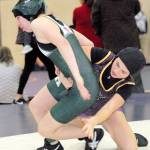 Keith Thorpe/Peninsula Daily News Trinity Laws of Port Angeles, left, tries to escape the grasp of Sequims Alexi Rampp-Taft in the 120 lb. weight class during Saturdays sub-regional tournament.