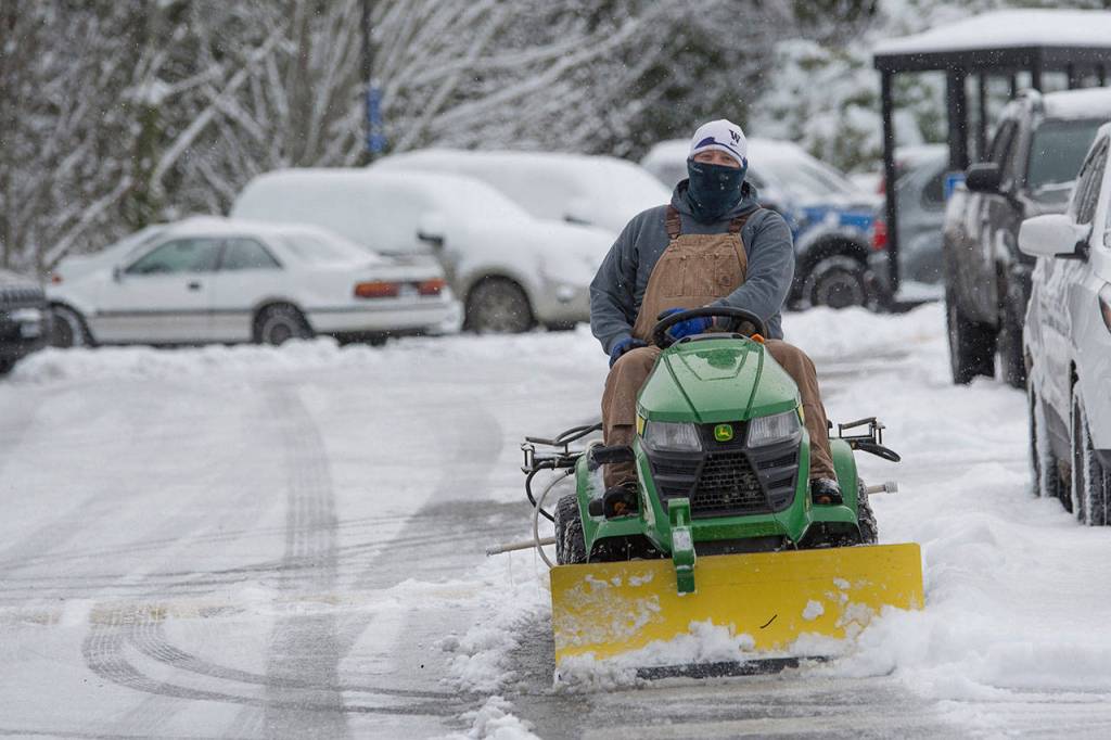 County crews plowed and put de-icer down in the parking lot at the Clallam County Courthouse. (Jesse Major/Peninsula Daily News)