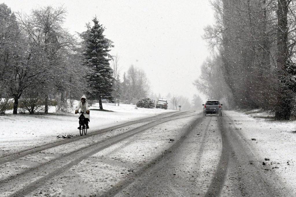 Traditional and alternative transportation modes were used Friday afternoon to get around on snow-blanketed San Juan Avenue in Port Townsend. (Jeannie McMacken/Peninsula Daily News)