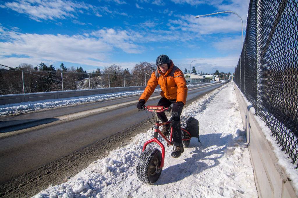 Steve Breitbach rides an Extreme Terrain bike on Eighth Street in Port Angeles on Sunday. (Jesse Major/Peninsula Daily News)