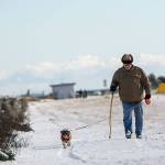 Walter Lawings of Port Angeles walks his dog Boo Bear at Ediz Hook on Sunday. (Jesse Major/Peninsula Daily News)