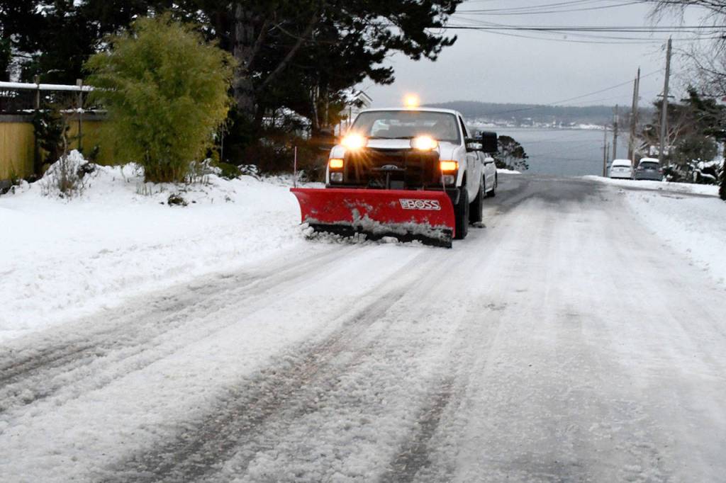 Port Townsend road crews were out Monday afternoon working to clear some of the ice and snow from the uptown districts side streets. Major streets in the business district were clear and wet, but residential areas were still slick. (Jeannie McMacken/Peninsula Daily News)