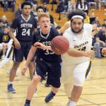 Spartan Iziah Morton (right) competes with Seton Catholics Andrew Olson (33) for ball control Thursday night in Chehalis during the 1A District 4 play-offs. Seton came back to defeat Forks 84 to 69 ending the Spartans season. Lonnie Archibald/for Peninsula Daily News