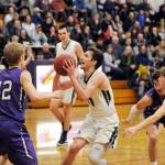 Michael Dashiell/Olympic Peninsula News Group Port Angeles Kyle Benedict (with ball) looks to shoot while defended by, from left, Sequims Erik Christiansen, Nate Despain and Kyler Rollness during the Riders 50-40 district win over the Wolves at Sequim High School.