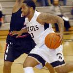 Keith Thorpe/Peninsula Daily News Peninsulas Davien Harris-Williams drives past the defense of Olympics Will Johnson in the opening minutes of Friday nights matchup in Port Angeles.