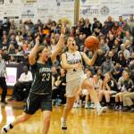 Michael Dashiell/Olympic Peninsula News Group Port Angeles Madison Cooke, left, attempts to block the layup attempt of Sequims Jessica Dietzman during a game last month. The two teams learned their state regional opponents, dates and game times Tuesday.