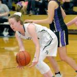 Keith Thorpe/Peninsula Daily News Port Angeles Mikkiah Brady, left, scoops up a loose ball as Sequims Jessica Dietzman looks on during their game in January,