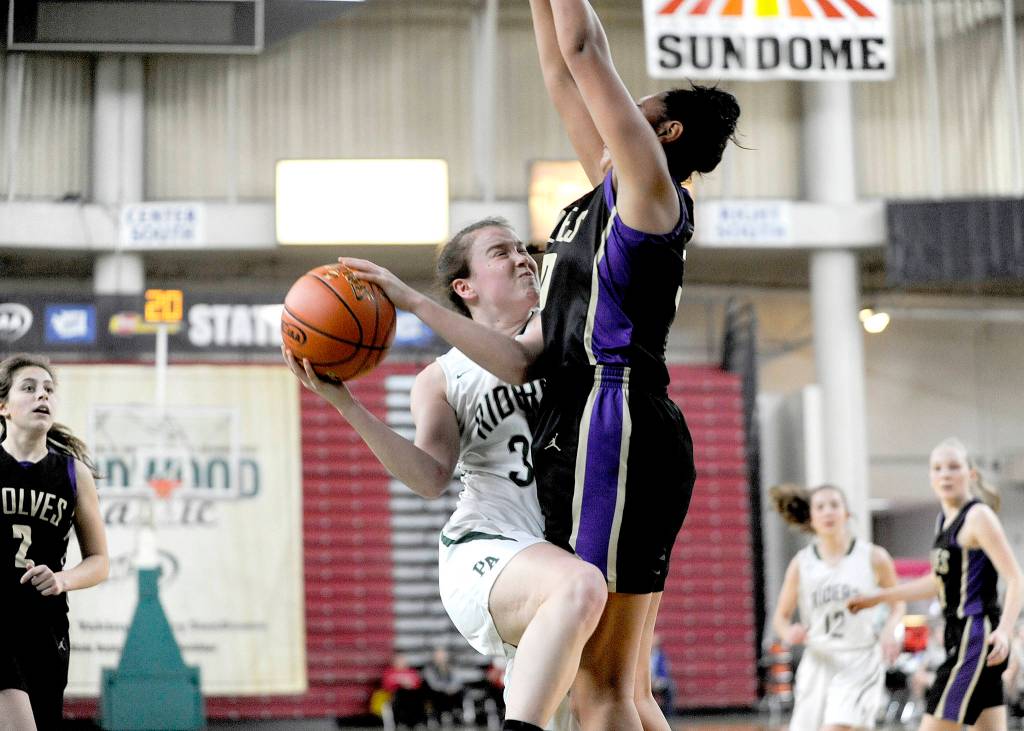 Michael Dashiell/Olympic Peninsula News Group                                Port Angeles Jaida Wood drives against Sequims Jayla Julmist early in the Roughriders 57-47 win over the Wolves. Julmist blocked this shot, one of three blocks in the game for the sophomore.