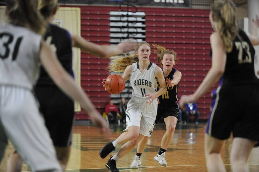 Michael Dashiell/Olympic Peninsula News Group Port Angeles Millie Long dribbles up the court during the Roughriders 57-47 win over Sequim at the Yakima SunDome on Wednesday. Long had 10 points and five steals in the win.