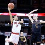 Neah Bays Laila Greene takes a shot over Sunnyside Christians Sydney Banks at the girls 1B state basketball tournament in Spokane. The Red Devils won 62-51 and will be playing in the state semifinals against No. 1 Colton today. (Chris Johnson/for Peninsula Daily News)