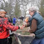 Tribal members prepare a canoe before its removed from Pioneer Memorial Park in Sequim in this file photo from April 2017. The story of the canoes journey from the park to the West End is the topic of Sundays History Tales presentation. (Michael Dashiell/Olympic Peninsula News Group)