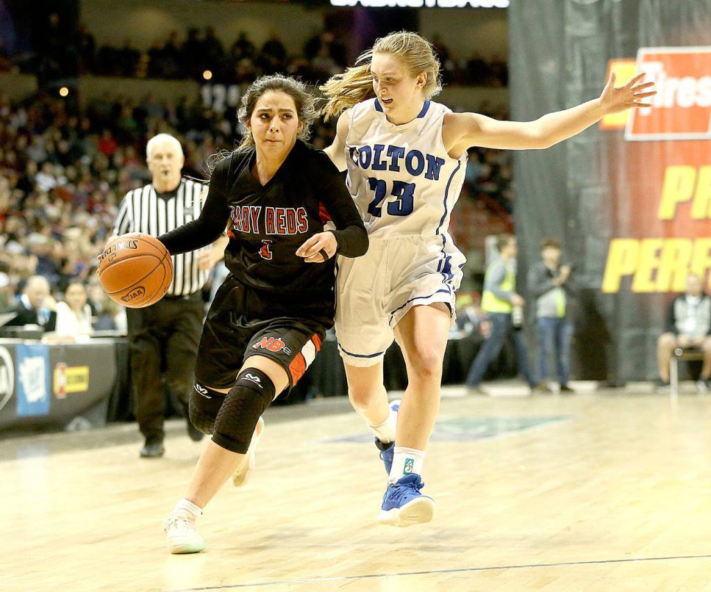 Neah Bays Courtney Swan brings the ball up the court in the Class 1B State Basketball Semifinals against Coltons Jordyn Moehrle on Friday. (Chris Johnson/for Peninsula Daily News)