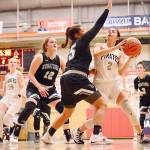 Jay Cline Peninsulas Leilani Padilla looks to shoot against Wenatchee Valleys Cariann Kunkel (12) and Ashley Peralta (25). At left is Peninsulas Kameron Bowen.