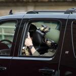 Michele Obamas motorcade, which included armed police guards, waits in the alley behind the Tacoma Public Library on Sunday. (Olivia Sullivan/Federal Way Mirror)
