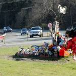 Traffic passes a roadside memorial on Tuesday to Brooke Bedinger, who died in a motorcycle wreck on U.S. Highway 101 at Morse Creek near Port Angeles on June 21. The state House has proposed funding for a barrier. (Keith Thorpe/Peninsula Daily News)