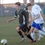 Keith Thorpe/Peninsula Daily News Port Angeles Andrew St. George, left, races Bremertons Sebastian Burdick downfield on Tuesday in Port Angeles. Following behind are teammate, Austin Fischer and Bremertons Luis Clemen.