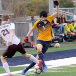 Lonnie Archibald/for Peninsula Daily News Forks Seth Johnson, right, is learning new techniques in his first year on the Spartans soccer team. Johnson competes with Montesanos Joseph Wood for ball control during Forks 2-0 loss to Montesano Wednesday at Spartan Stadium.