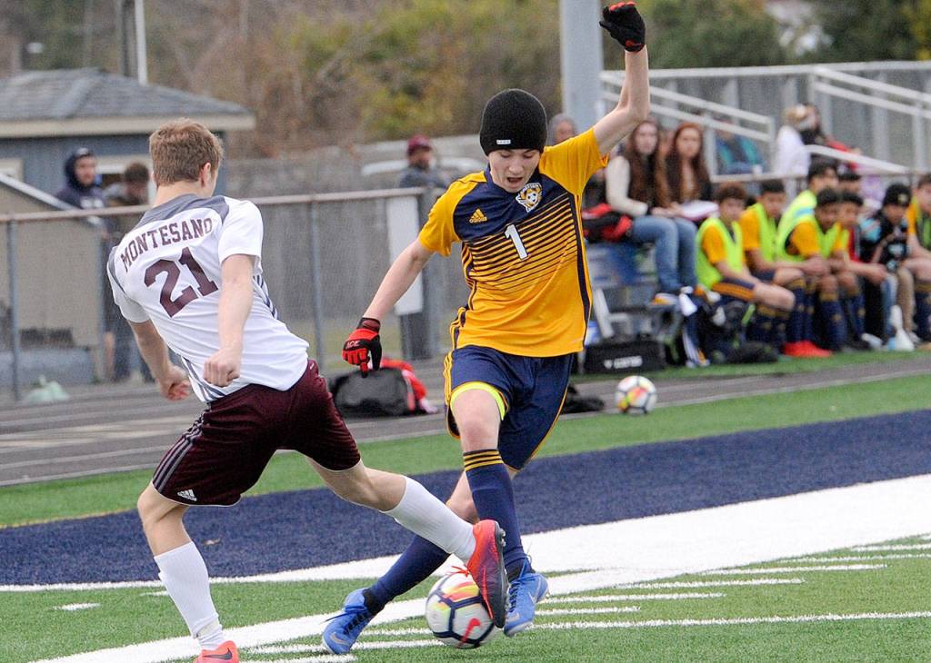 Lonnie Archibald/for Peninsula Daily News Forks Seth Johnson, right, is learning new techniques in his first year on the Spartans soccer team. Johnson competes with Montesanos Joseph Wood for ball control during Forks 2-0 loss to Montesano Wednesday at Spartan Stadium.