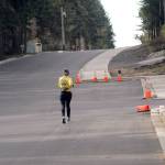 A jogger makes her way along a portion of West 10th Street at South M Street on Wednesday in Port Angeles. The street will be closed for up to two weeks in April for paving, part of a street rehabilitation project that began last year. (Keith Thorpe/Peninsula Daily News)