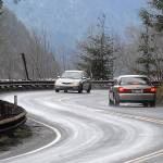 Keith Thorpe/Peninsula Daily News Cars make their way around a curve on U.S. Highway 101 at Lake Crescent west of Port Angeles on Wednesday.