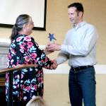 Hans Frederickson, owner of Frederickson Electric, accepts the Business Leader of the Year award from Betsy Davis, the executive director of the Northwest School of Wooden Boatbuilding, during the Chamber of Jefferson County luncheon Sunday at the Old Alcohol Plant in Port Hadlock. (Brian McLean/Peninsula Daily News)