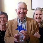 Myron Vogt, center, was honored Sunday by the Chamber of Jefferson County as its 2018 Citizen of the Year during a ceremony at the Old Alcohol Plant in Port Hadlock. He was joined by his wife, Valeria, left, and his daughter, Jennifer Molloy. (Brian McLean/Peninsula Daily News)