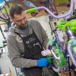 Mechanic CJ Knoph works on a bike at the ReCyclery. (Jesse Major/Peninsula Daily News)