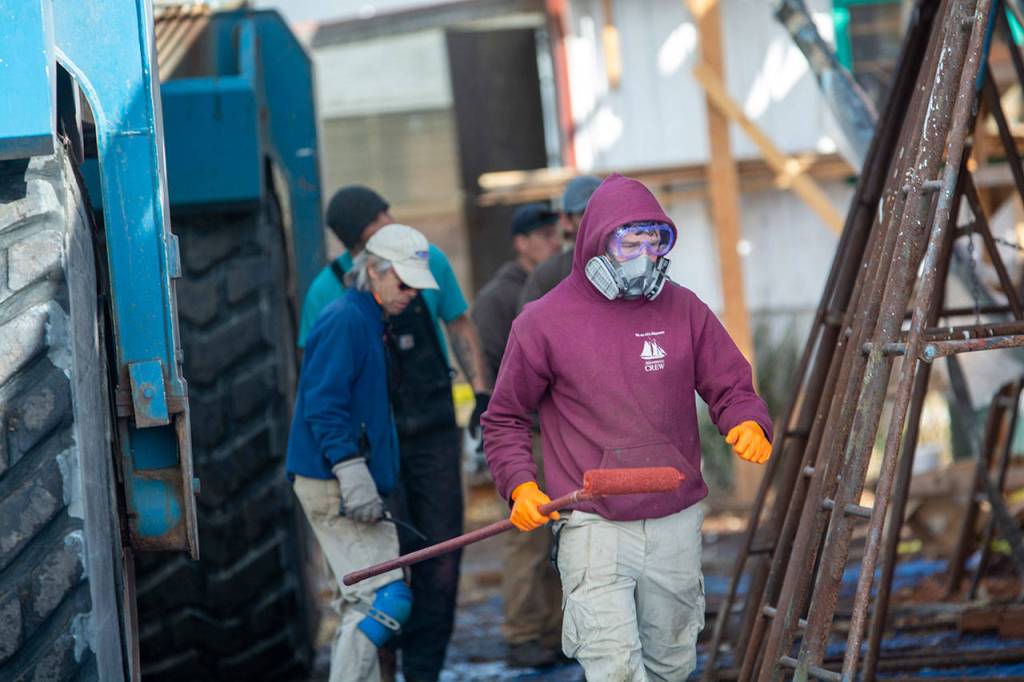 Crews work on the schooner Adventuress before it is taken to the water Friday. (Jesse Major/Peninsula Daily News)