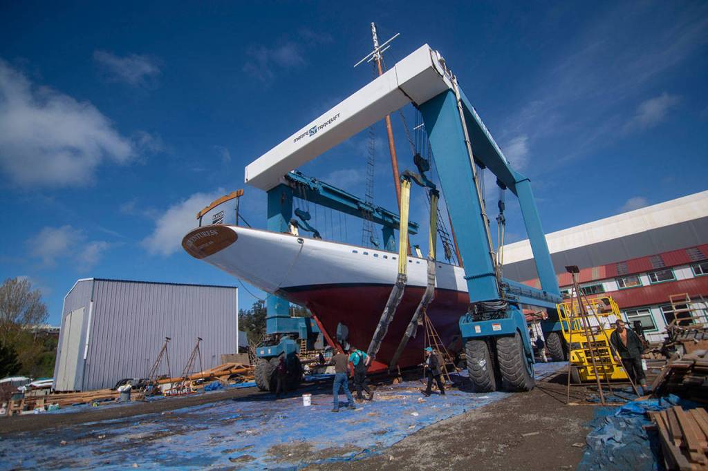 The schooner Adventuress waits in a 300-ton lift before being put in the water Friday. (Jesse Major/Peninsula Daily NEws)