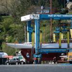 Crowds follow as the schooner Adventuress makes its way across the boatyard in Port Townsend. (Jesse Major/Peninsula Daily News)
