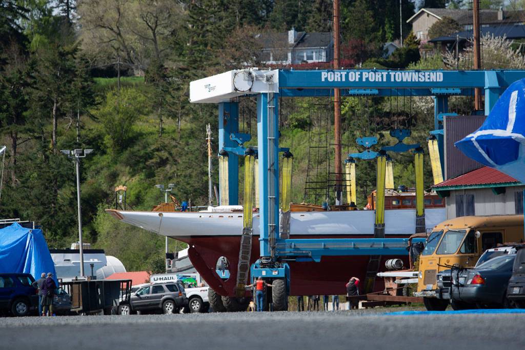 Crowds follow as the schooner Adventuress makes its way across the boatyard in Port Townsend. (Jesse Major/Peninsula Daily News)