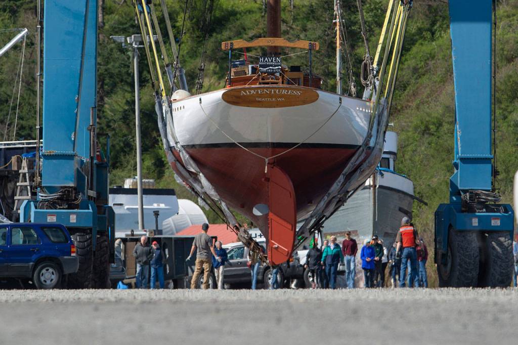 Crowds follow as the schooner Adventuress makes its way across the boatyard in Port Townsend. (Jesse Major/Peninsula Daily News)