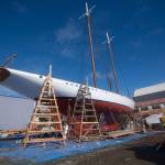 Crews prepare the schooner Adventuress before it is taken to the water Friday. (Jesse Major/Peninsula Daily News)