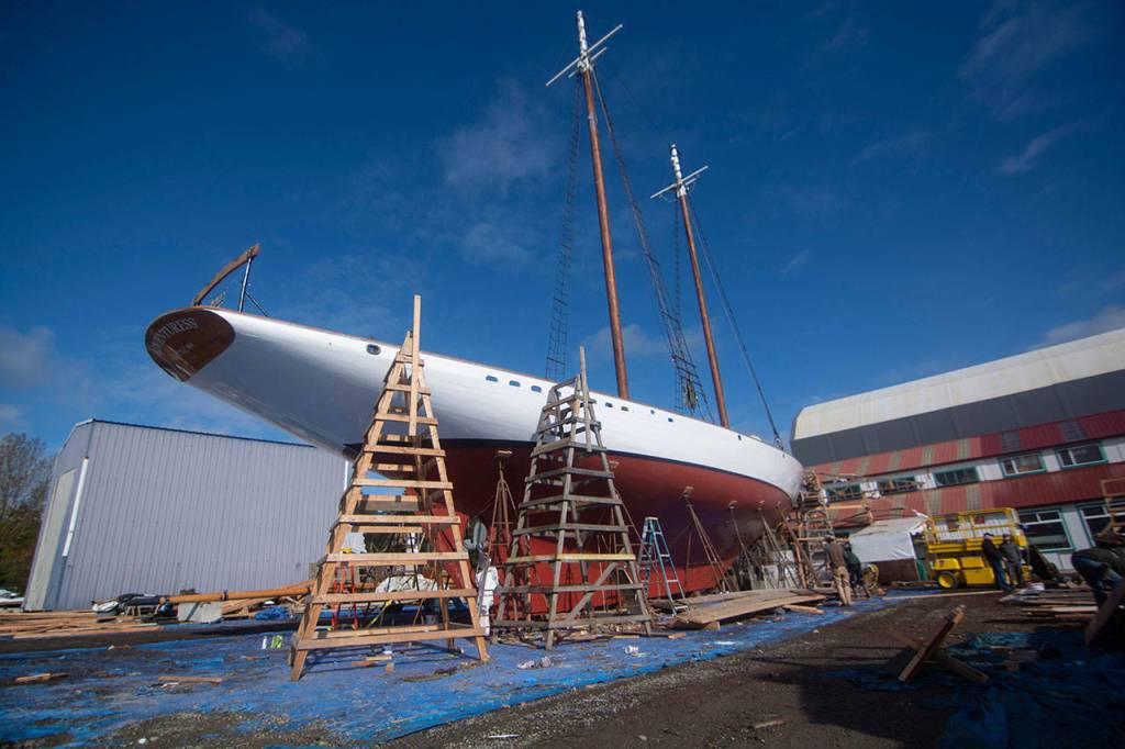 Crews prepare the schooner Adventuress before it is taken to the water Friday. (Jesse Major/Peninsula Daily News)