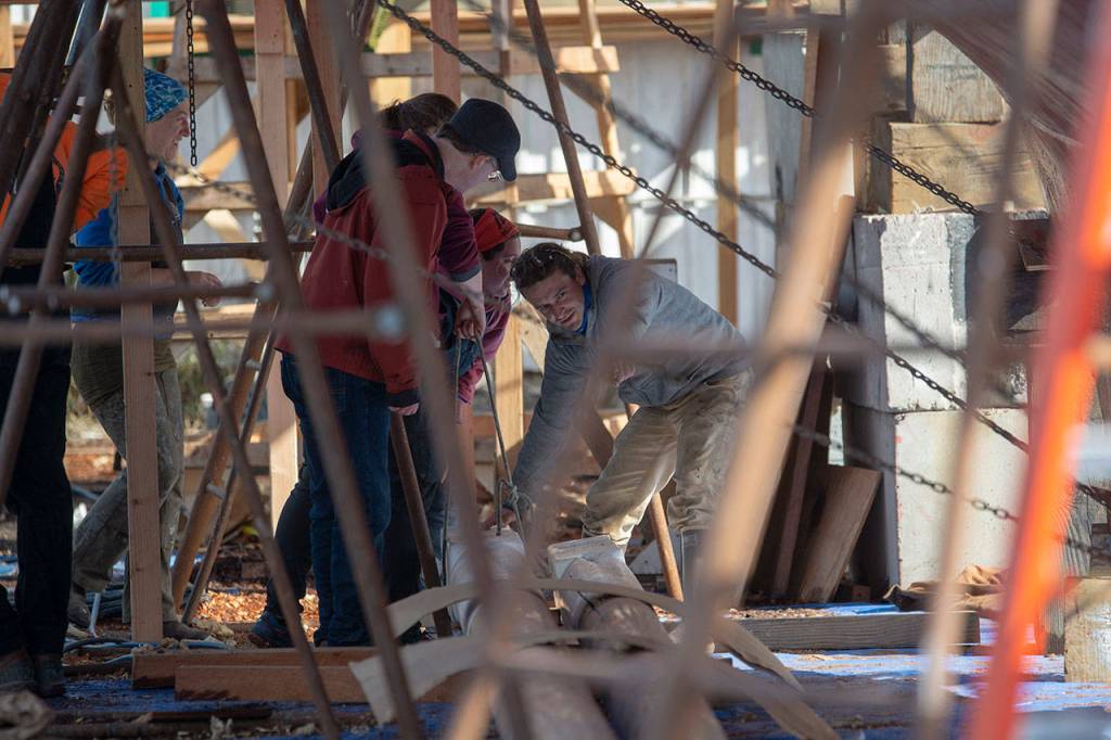 Crews prepare the schooner Adventuress before it is taken to the water Friday. (Jesse Major/Peninsula Daily News)