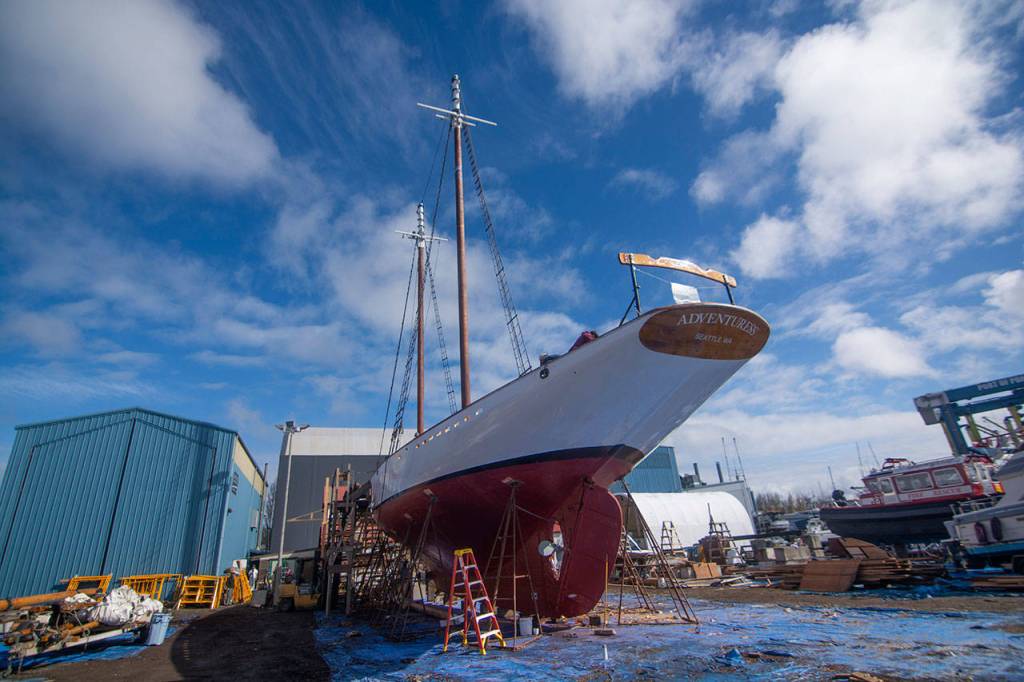 Crews prepare the schooner Adventuress before it is taken to the water Friday. (Jesse Major/Peninsula Daily News)