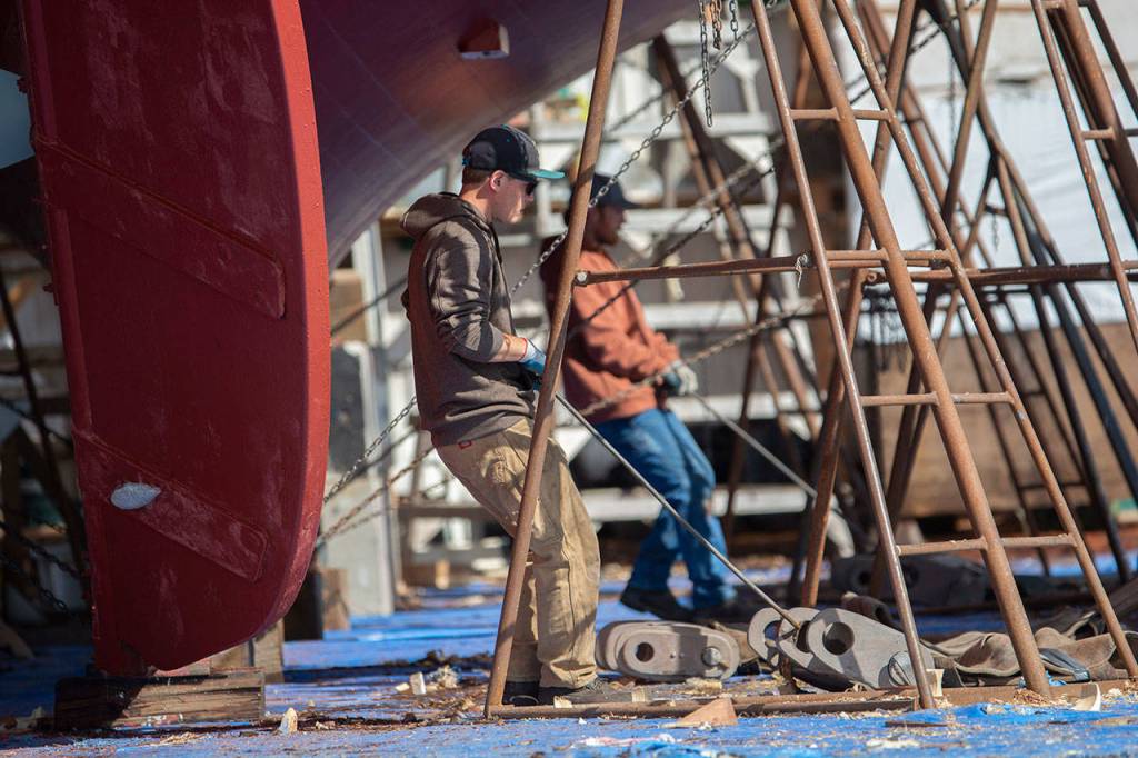 Crews prepare the schooner Adventuress before it is taken to the water Friday. (Jesse Major/Peninsula Daily News)