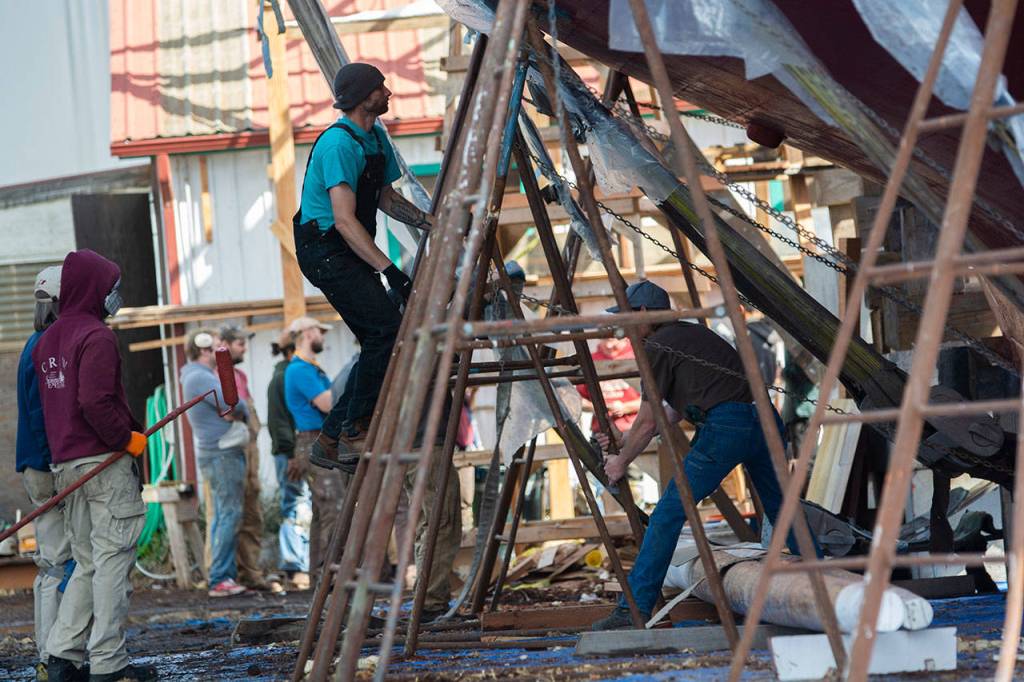 Crews work on the schooner Adventuress before it is taken to the water Friday. (Jesse Major/Peninsula Daily News)