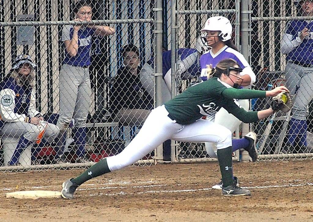 Keith Thorpe/Peninsula Daily News Port Angeles first baseman Aeverie Politika reaches long for the throw, beating North Kitsaps Alicia Goetz for the out in second inning on Friday at the Dry Creek athletic fields in Port Angeles.