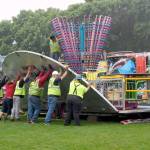 Funtastic carnival workers begin setting up the Umbrella Ride, one of the attractions last year for Rhody Week festivities. (Jeannie McMacken/Peninsula Daily News)
