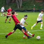 Port Townsends Silas DeWyse pokes the ball away from Forks Hugo Sandoval during a boys soccer match Tuesday at Memorial Field in Port Townsend.                                Steve Mullensky/for Peninsula Daily News