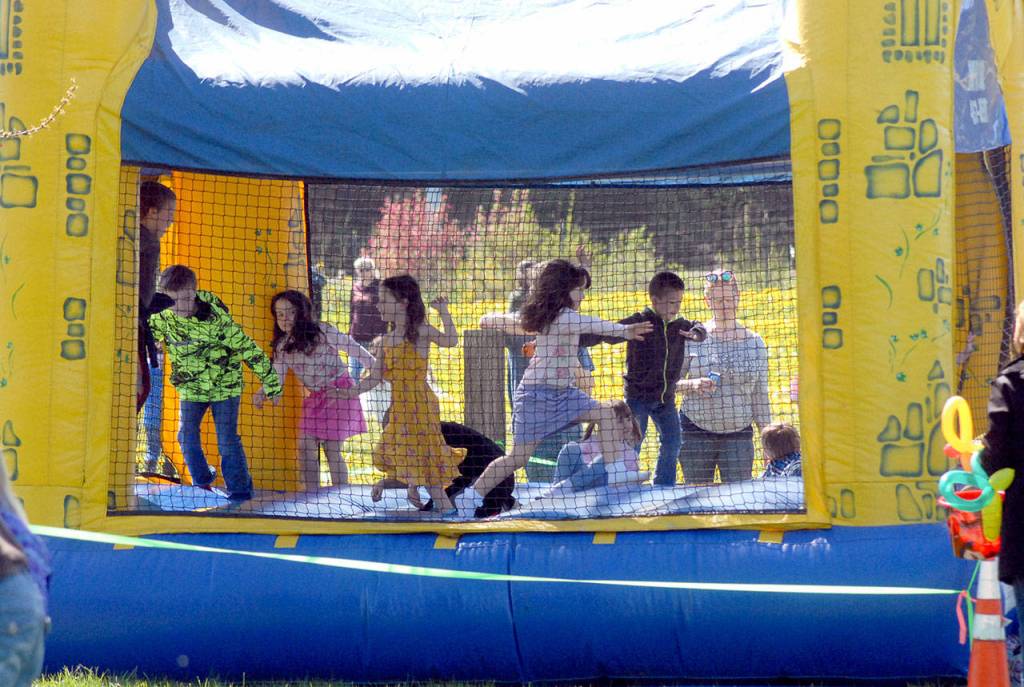 Children cavort in an inflatable bounce house at the Pumpkin Patch on Saturday. (Keith Thorpe/Peninsula Daily News)