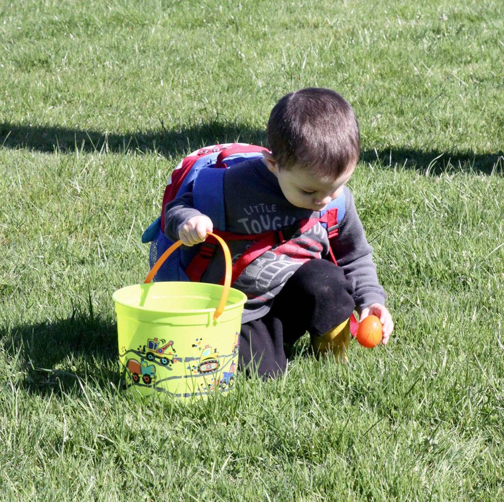 Ezra Garcia, 2 1/2 of Joyce, grabs for another plastic egg at the Kitchen Family Easter Egg Hunt in Joyce on Saturday. The 17th annual Kitchen Family Community Easter Egg Hunt was a great success this year on the grounds of Crescent School with several hundred young children and their parents dashing for plastic eggs with prizes inside. (David Logan/for Peninsula Daily News)
