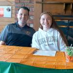 Clallam Bay High Schools Hannah Olson, right, signed on Friday to play basketball for Walla Walla University at the Breakwater Restaurant. With her is her college coach Paul Starkebaum. Olson, a Neah Bay resident and a member of the Makah Tribe, played basketball and volleyball for Clallam Bay and is wrapping up her final track season at the school.