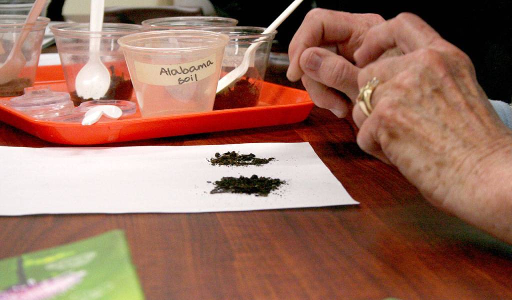 Each container of soil was labeled so workshop participants could shift through them and try to pick out differences. The composting class covered information about how to start a composting bin in your own backyard. (Brian McLean/Peninsula Daily News)