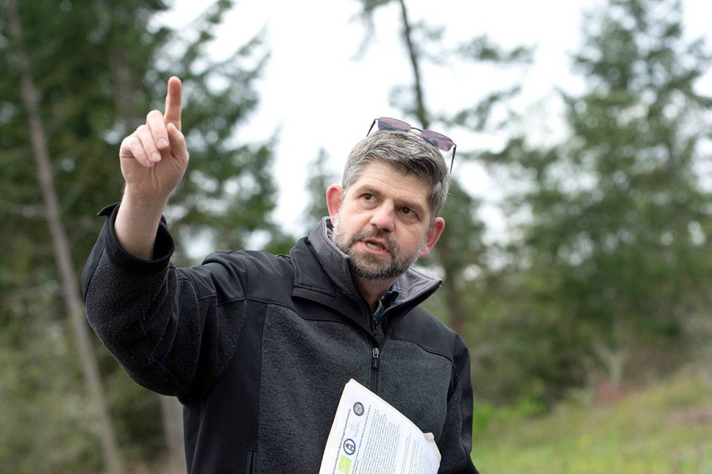 Clallam County Commissioner Mark Ozias talks about the proposed Dungeness Off-Channel Reservoir during the tour. (Jesse Major/Peninsula Daily News)