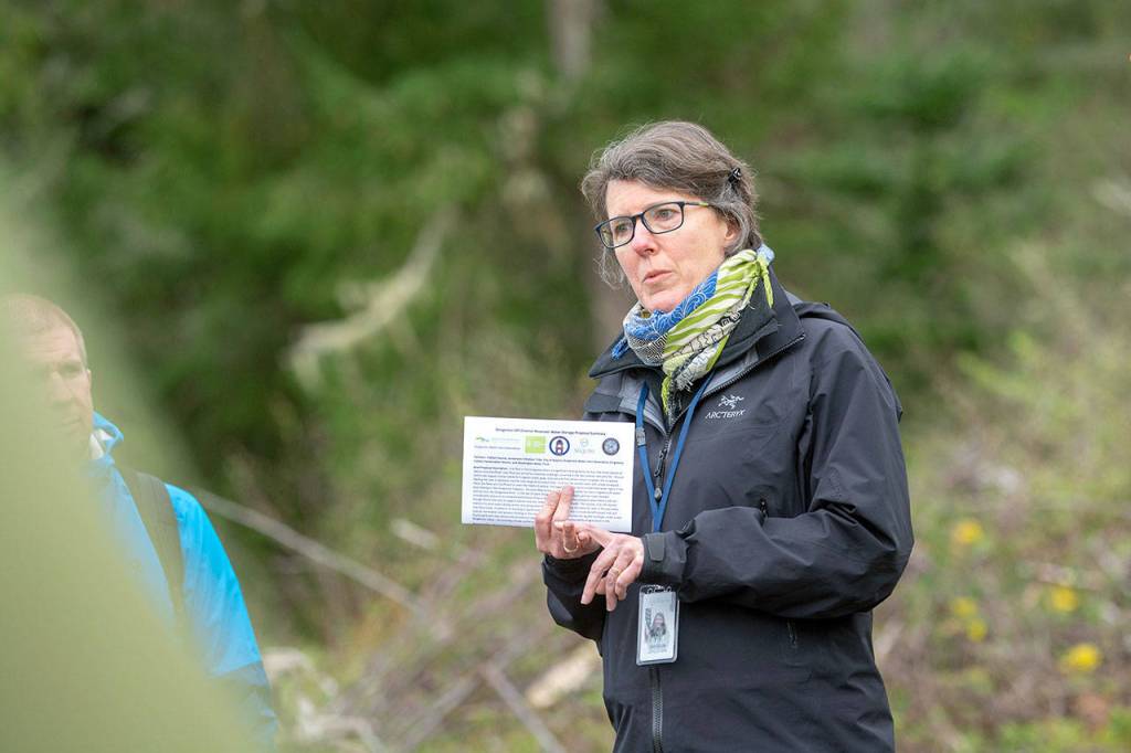 Ann Soule, resource manager for the city of Sequim, discusses the Dungeness Off-Channel Reservoir during the tour. (Jesse Major/Peninsula Daily News)